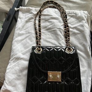 Black patent leather clutch with gold and black chain strap excellent condition.